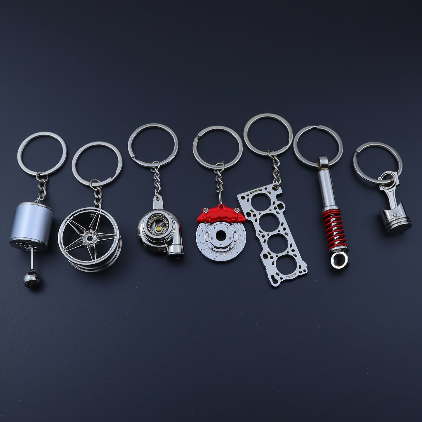 🗝️ 7-częściowy zestaw breloków tuningowych – Piston, Turbo, Wheel Hub, Gear Shift, Shock Absorber, Brake Disc, Engine Block – czarny, zinc alloy