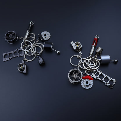 🗝️ 7-częściowy zestaw breloków tuningowych – Piston, Turbo, Wheel Hub, Gear Shift, Shock Absorber, Brake Disc, Engine Block – czarny, zinc alloy