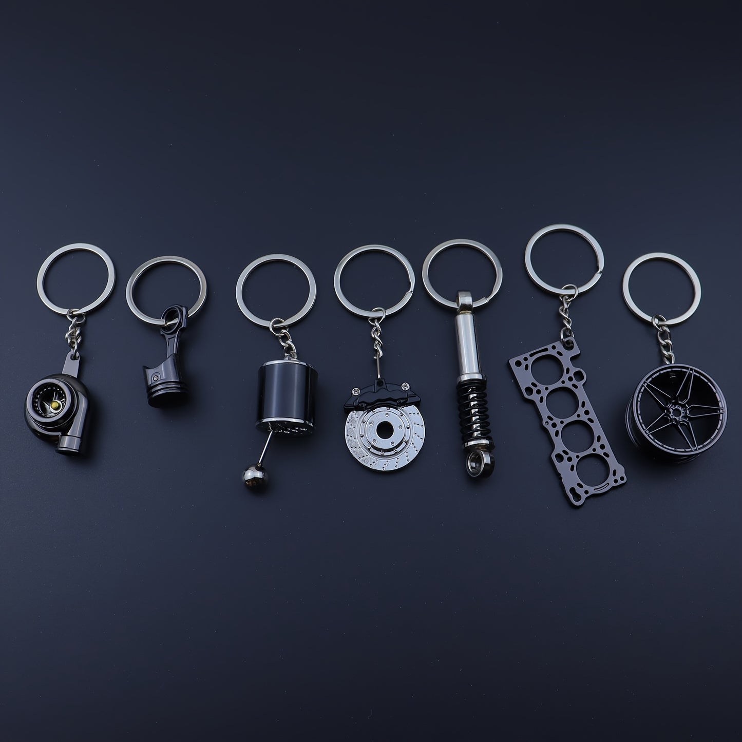 🗝️ 7-częściowy zestaw breloków tuningowych – Piston, Turbo, Wheel Hub, Gear Shift, Shock Absorber, Brake Disc, Engine Block – czarny, zinc alloy