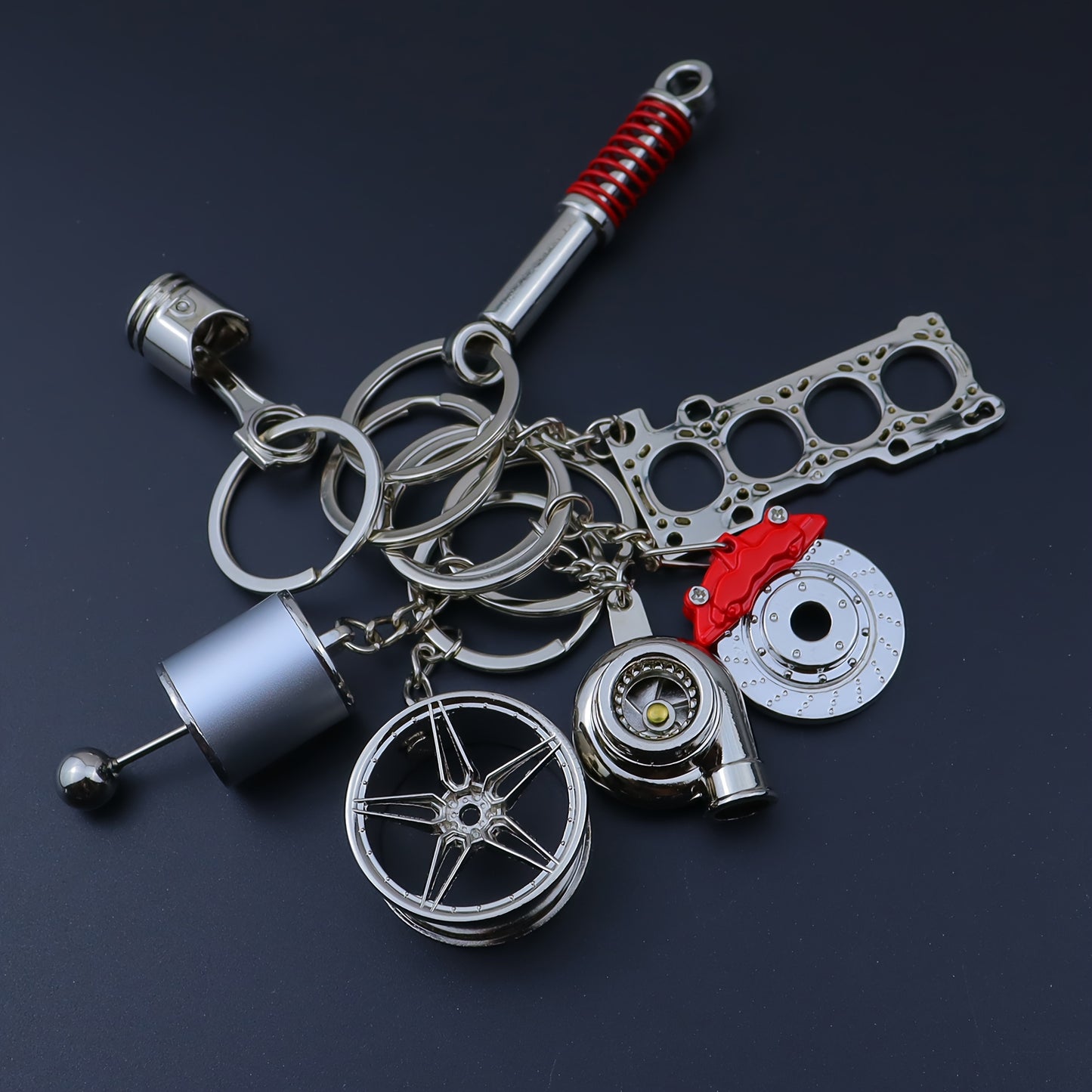 🗝️ 7-częściowy zestaw breloków tuningowych – Piston, Turbo, Wheel Hub, Gear Shift, Shock Absorber, Brake Disc, Engine Block – czarny, zinc alloy